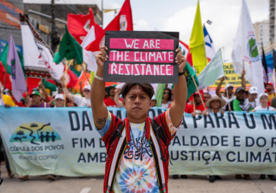 Protesters with banner and signs at COP30