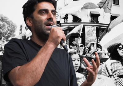 Surya McEwen against a backdrop of protesters