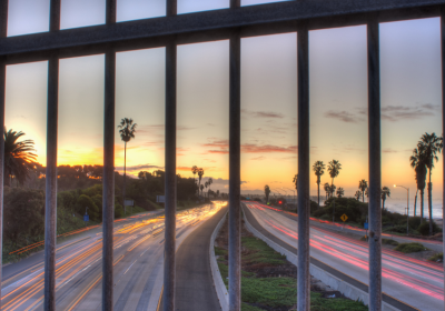 View of a highway from behind a fence
