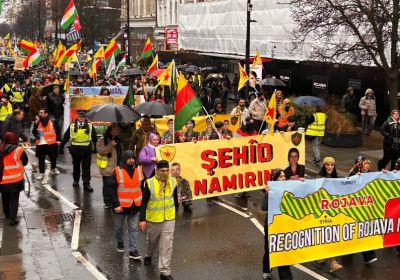 Protesters holding signs and banners and marching in London