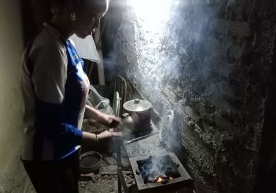 Cuban woman cooks with charcoal