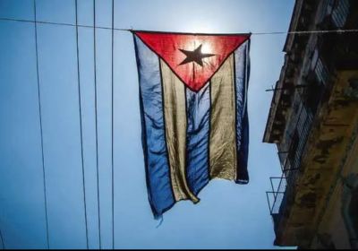 Cuban flag hanging accross a street on a wire