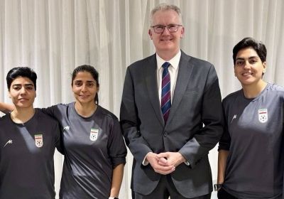 Tony Burke with members of the Iranian women's football team. (Supplied: Department of Home Affairs)