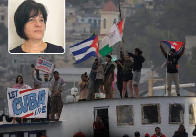 people on a boat waving Cuban flags, Cuban Ambassador