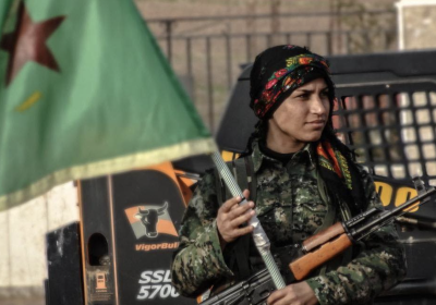 YPJ fighter carrying a flag