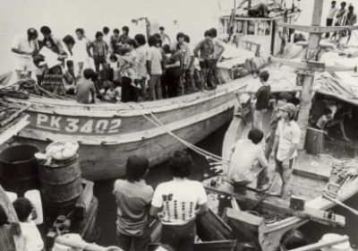 Black and white photograph of refugees on boats, unknown photographer, location and date.