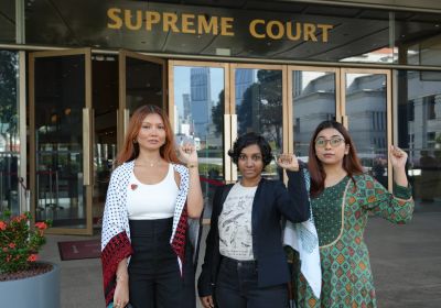 Three activists outside the Supreme Court