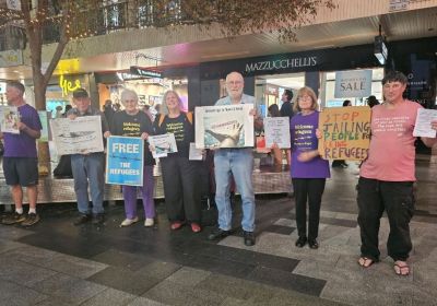 Supporters of the Adelaide Vigil for Manus and Nauru in Rundle Mall holding signs and placards supporting refugees.