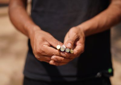 person holding bullet casings