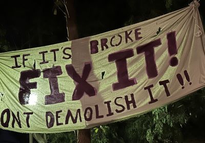 Cropped photo of banner that says "If it's broke Fix It! Don't demolish it!"