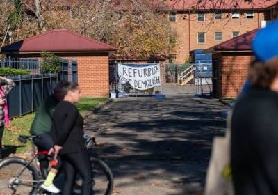 Photo of protestors at the Save Waterloo Encampment with a banner in the background that has Refurbish Don't Demolish printed on it