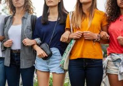 A photo of people standing together with their arms linked