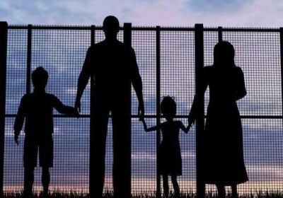 Artwork of a refugee family being a detention centre fence