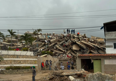 people standing on top of building rubble