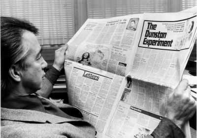 Don Dunstan reading a newspaper