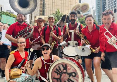 Group photo of rhe Riff Raff Radical Marching Band Magandjin/Brisbane crew in Magan-djin with thier instruments